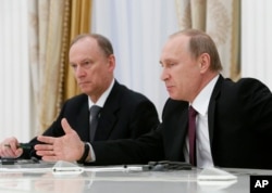 FILE - Analyst Alexander Golts tells VOA that many top Russian officials — including President Vladimir Putin, right, and Russian Security Council Secretary Nikolai Patrushev — have used false quotes for effect.