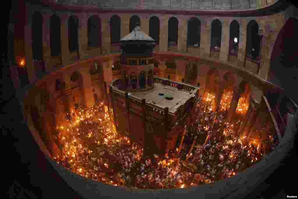 Worshipers hold candles in the Christian Orthodox Holy Fire ceremony at the Church of the Holy Sepulchre in Jerusalem's Old city.