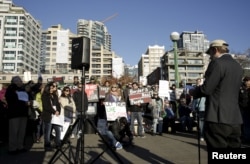 FILE - People participate in a pro-refugee protest organized by Americans for Refugees and Immigrants in Seattle, Washington, Nov. 28, 2015.