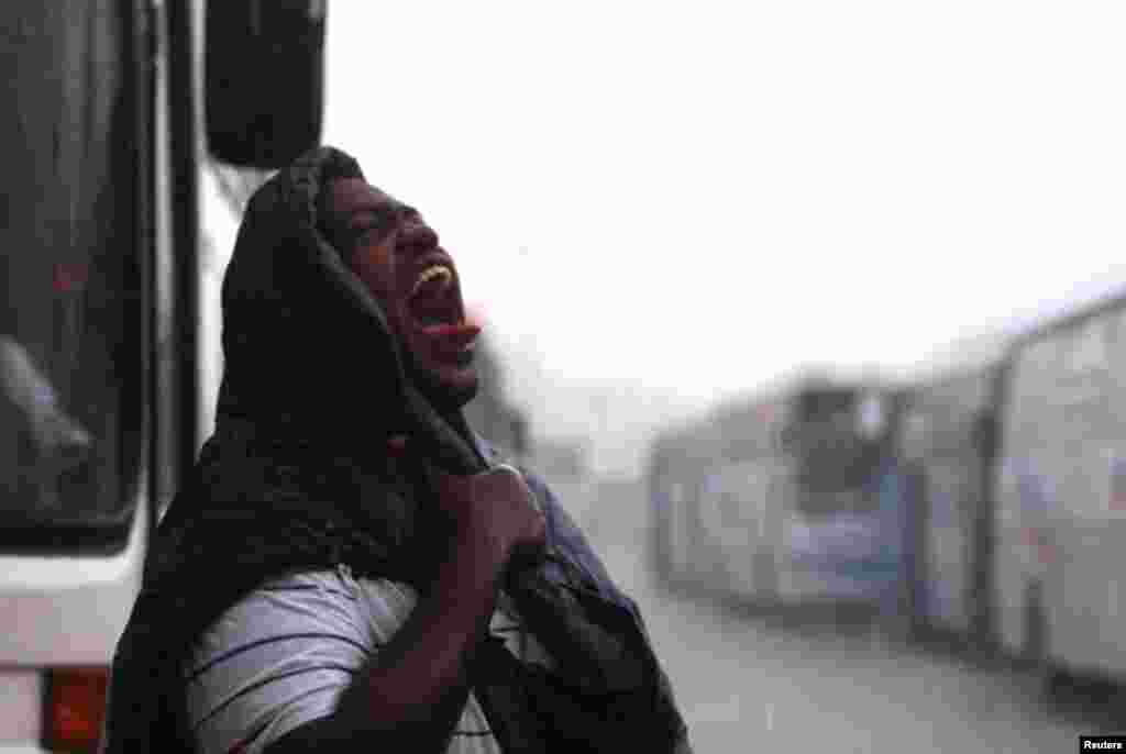 A Muslim pilgrim walks under heavy rain in Mena November 18, 2010. Millions flock to Mecca in Saudi Arabia for the annual haj pilgrimage, a duty for every able-bodied Muslim who can afford it. Muslims around the world celebrate Eid al-Adha to mark the end