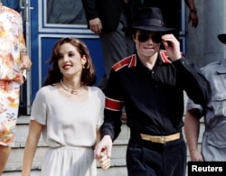FILE PHOTO: Popstar Michael Jackson and his bride Lisa Marie Presley-Jackson hold each others hands in Budapest