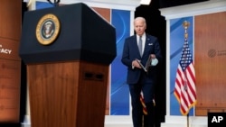 President Joe Biden arrives to deliver closing remarks to the virtual Summit for Democracy, in the South Court Auditorium on the White House campus, Friday, Dec. 10, 2021.