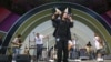 Asdru Sierra, center, of Ozomatli, performs during the Playboy Jazz Festival in Los Angeles, Sunday, June 18, 2006.