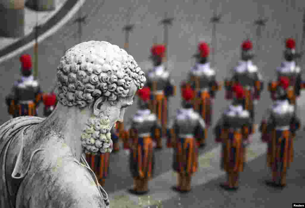 Swiss guards stand at attention before the start of the Easter mass led by Pope Francis in St. Peter&#39;s Square at the Vatican. (Alessandro Bianchi.)