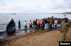 Rescue and recovery teams gather at the shores of Lake Victoria during the search for the bodies of passengers after a cruise boat capsized off Mukono district, Uganda, Nov. 25, 2018.