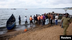 Rescue and recovery teams gather at the shores of Lake Victoria during the search for the bodies of passengers after a cruise boat capsized off Mukono district, Uganda, Nov. 25, 2018.