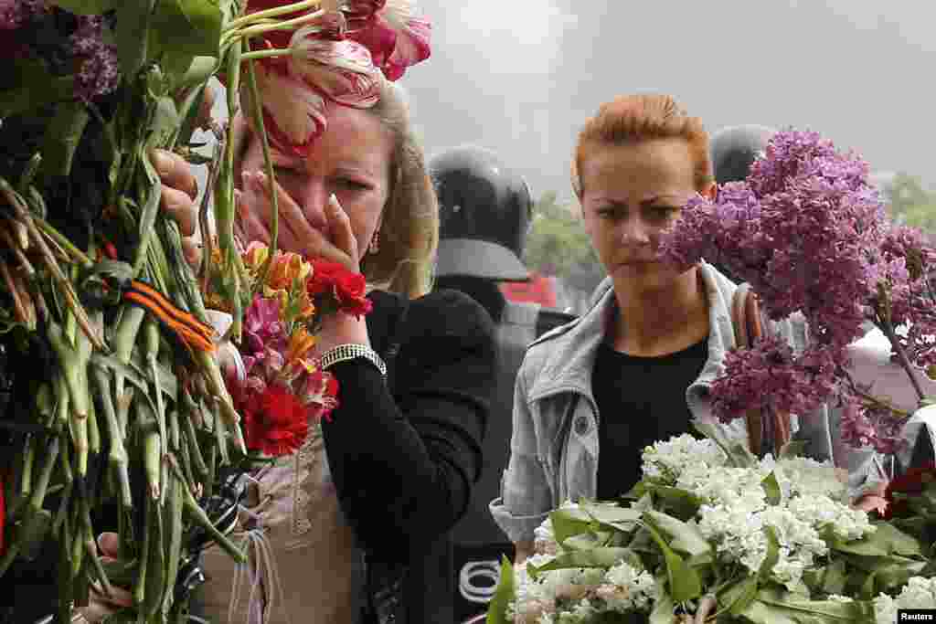 Women bring flowers in memory of people killed in recent street battles outside a trade union building, where a deadly fire occurred, in Odessa. At least 42 people were killed in street battles between supporters and opponents of Russia in southern Ukraine that ended with pro-Russian protesters trapped in a flaming building.