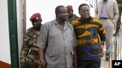 Guinea-Bissau's army chief of staff Antonio Indjai (C) and head of the national electoral commission Desejado Lima da Costa (R) arrive at a news conference at military headquarters in the capital Bissau, March 19, 2012.