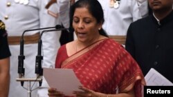 India's ruling Bharatiya Janata Party (BJP) politician and member of parliament Nirmala Sitharaman takes the oath during the swearing-in ceremony of new ministers at the Presidential Palace in New Delhi, Sept. 3, 2017.