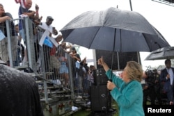 U.S. Democratic presidential nominee Hillary Clinton acknowledges the crowd at a campaign rally in the rain in Pembroke Pines, Fla., Nov. 5, 2016.