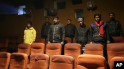 Indian moviegoers stand as national anthem is played at a cinema in Allahabad, India, Jan. 9, 2018.