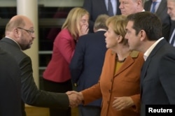 From left, European Parliament President Martin Schulz, Germany's Chancellor Angela Merkel and Greece's Prime Minister Alexis Tsipras chat after a meeting about the Balkan refugee crisis with leaders from central and eastern Europe, Oct. 25, 2015.