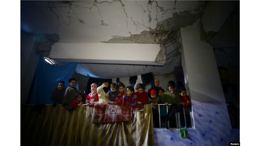 Children are seen in a shelter in the besieged town of Douma, eastern Ghouta, near Damascus, Syria, March 11, 2018.