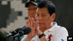 Philippine President Rodrigo Duterte gestures while addressing the Philippine Army Scout Rangers during his visit to their headquarters at Camp Tecson in San Miguel township, north of Manila, Philippines, Sept. 15, 2016.