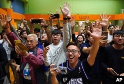Supporters of pro-democracy candidate Angus Wong celebrate after he won in district council elections in Hong Kong, early Nov. 25, 2019.