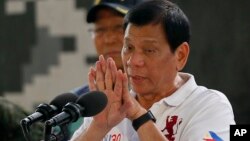 Philippine President Rodrigo Duterte gestures while addressing the Philippine Army Scout Rangers during his visit to their headquarters at Camp Tecson in San Miguel township, north of Manila, Philippines, Sept. 15, 2016.