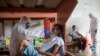 COVID-19 patients are assisted by medical staff in protective equipment at the regional hospital in Iquitos, the largest city in the Peruvian Amazon, May 9, 2020.