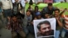 FILE - Pakistani journalists protest to condemn an attack on their colleague, Ahmed Noorani, pictured in the poster, in Karachi, Pakistan, Oct. 30, 2017.