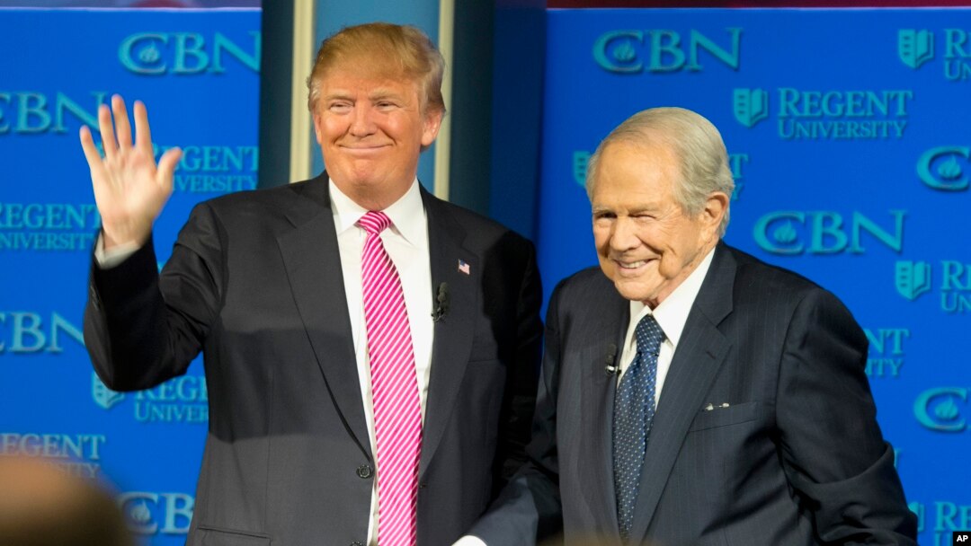 On Feb. 24, 2016, Republican presidential candidate, Donald Trump, accompanied by Rev. Pat Robertson, waves as he arrives for an appearance at Regent University in Virginia Beach, Virginia.