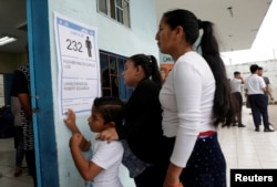 Voters wait in line to cast their votes in the presidential election in a public school, used as a polling station, in Guayaquil, Ecuador, Feb. 19, 2017.