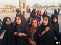 FILE - Afghan refugee girls gather at the Bardsir settlement for Afghan refugees in Kerman province, Iran, Oct. 22, 2016.