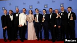 FILE - The cast and crew of "La La Land" pose after winning the award for Best Motion Picture - Musical or Comedy among other awards backstage during the 74th Annual Golden Globe Awards in Beverly Hills, California, Jan. 8, 2017. 