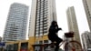 A woman cycles past a building registered to Huaying Haitai Science and Technology Development Co. in Tianjin, China, the alleged employer of two Chinese nationals indicted by the United States on hacking charges on December 21, 2018. (Reuters)