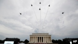 The U.S. Army Band performs and the U.S. Navy Blue Angels fly over at the end of an Independence Day celebration in front of the Lincoln Memorial, July 4, 2019, in Washington.