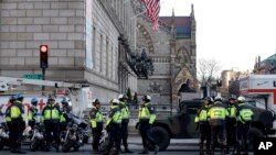 Boston police officers keep a perimeter secure in Boston's Copley Square as an investigation continues into the bomb blasts at the finish area of the Boston Marathon which killed 3 and injured over 140 people, April 16, 2013.