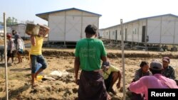 People work inside a camp set up by Myanmar's Social Welfare, Relief and Resettlement Minister to prepare for the repatriation of displaced Rohingyas, who fled to Bangladesh, outside Maungdaw in the state of Rakhine, Myanmar, Jan. 24, 2018.