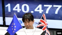 A monitor displays the exchange rate of the Japanese yen against the British Pound as a trader works at a foreign exchange brokerage in Tokyo, Japan, June 24, 2016.