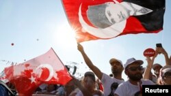 People wave Turkish flags during a rally to mark the end of the main opposition Republican People's Party (CHP) leader Kemal Kilicdaroglu's 25-day long protest, dubbed "Justice March," against the detention of the party's lawmaker Enis Berberoglu, in Istanbul, Turkey July 9, 2017.