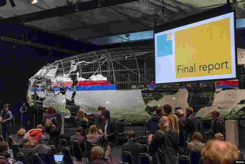 The reconstructed airplane serves as a backdrop during the presentation of the final report into the July 2014 crash of Malaysia Airlines flight MH17, in Gilze Rijen, the Netherlands, October 13, 2015.