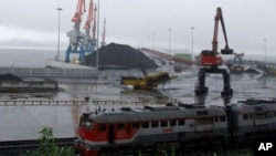 FILE - Coal brought from Siberia can be seen awaiting loading onto a ship bound for China in the North Korean special economic zone of Rason. The Liaoning Hongxiang Group allegedly sold North Korea aluminum bars and chemicals that have potential military purposes.