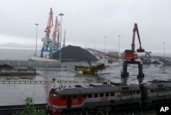 FILE - Coal brought from Siberia can be seen awaiting loading onto a ship bound for China in the North Korean special economic zone of Rason.