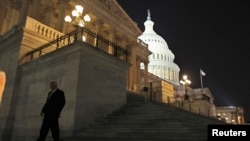 A member of the U.S. House of Representatives walks down the steps of the U.S. Capitol in Washington at nightfall September 30, 2013.