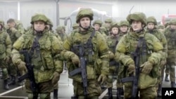 FILE - In this handout photo taken from video released by Russian Defense Ministry Press Service, Russian recruiters stand prior to their military training at the Patriot Park outside in Moscow, Russia, Saturday, Oct. 1, 2022. 