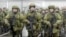 FILE - In this handout photo taken from video released by Russian Defense Ministry Press Service, Russian recruiters stand prior to their military training at the Patriot Park outside in Moscow, Russia, Saturday, Oct. 1, 2022. 