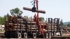 Seorang pekerja sedang membongkar kayu gelondongan di Murray Brothers Lumber Company di Madawaska, Ontario, Kanada, 4 Juli 2018. (Foto: Reuters)