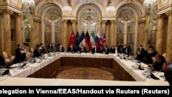 Deputy Secretary General of the European External Action Service (EEAS) Enrique Mora and Iran's chief nuclear negotiator Ali Bagheri Kani with delegations wait for the start of a meeting of the JCPOA Joint Commission in Vienna, Dec. 9, 2021. 