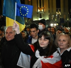 Georgian opposition supporters rally to protest results of the parliamentary elections that showed a win for the ruling Georgian Dream party, outside the parliament building in central Tbilisi on Oct. 28, 2024.