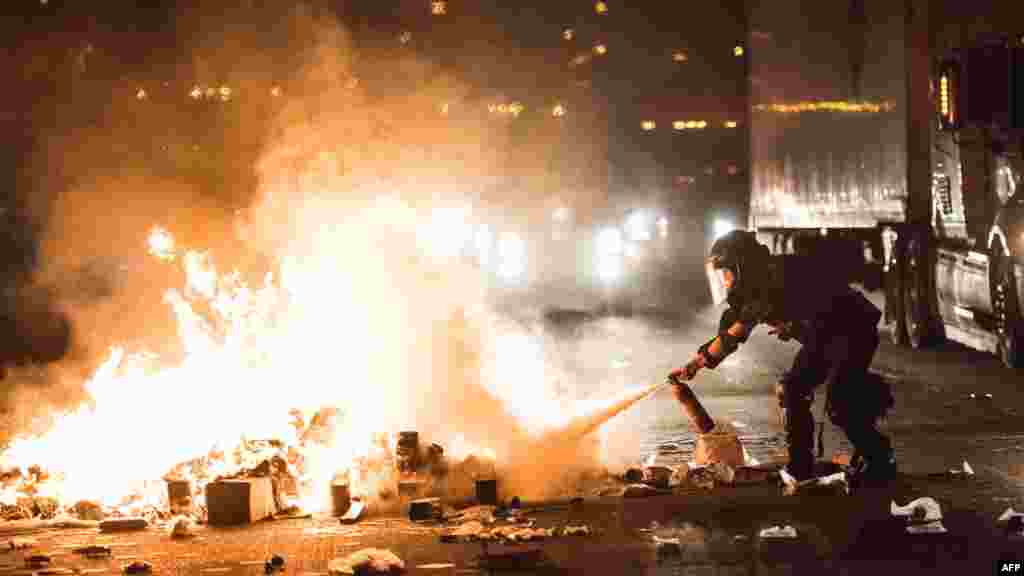 Un agent de police tente d&#39;éteindre le feu sur la I-85 lors de manifestations suite à la mort d&#39;un noir abattu par un agent de police à Charlotte, le 21 septembre 2016.