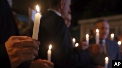 Lebanese citizens hold candles for slain Jordanian pilot, Lt. Muath al-Kaseasbeh, killed by the Islamic State group, during a candle light vigil in front of the Jordanian Embassy in Baabda, east of Beirut, Lebanon, Feb. 5, 2015.