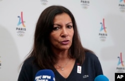 Paris Mayor Anne Hidalgo talks with reporters during a press conference in Lima, Peru, Sept. 10, 2017.