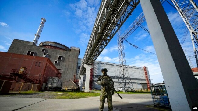 FILE - A Russian serviceman guards an area of the Zaporizhzhia nuclear power plant in territory under Russian military control, southeastern Ukraine, May 1, 2022.