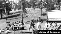 Photo by Frances Benjamin Johnston shows tourists and guides picnicking in Yellowstone National Park, 1903.