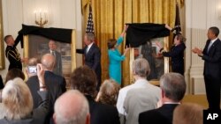 FILE - Then-President Barack Obama applauds at right as former President George W. Bush and former first lady Laura Bush unveil the Bush portraits during a ceremony in the East Room of the White House in Washington, May 31, 2012. 