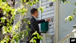 Dan Sideris, of Newton, Mass., rings a doorbell of a home as he and his wife return to door-to-door visits as Jehovah's Witnesses, Sept. 1, 2022, in Boston.