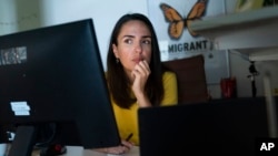 FILE - Juliana Macedo do Nascimento, 36, a Deferred Action for Childhood Arrivals program recipient who moved to the U.S. from Brazil when she was 14, participates in a Zoom call for her job with United We Dream, at her apartment in Washington, Sept. 2, 2022.