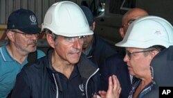 In this handout photo taken from video released by Russian Defense Ministry Press Service on Sept. 2, 2022, International Atomic Energy Agency (IAEA) director Rafael Grossi, center, and IAEA members inspect the Zaporizhzhia nuclear power plant in Ukraine,